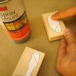 Use double-sided tape to create two stacks of three layers each and glue the paper pattern to the top