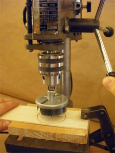 Cut circles with two sizes of hole saw mounted in a pillar drill