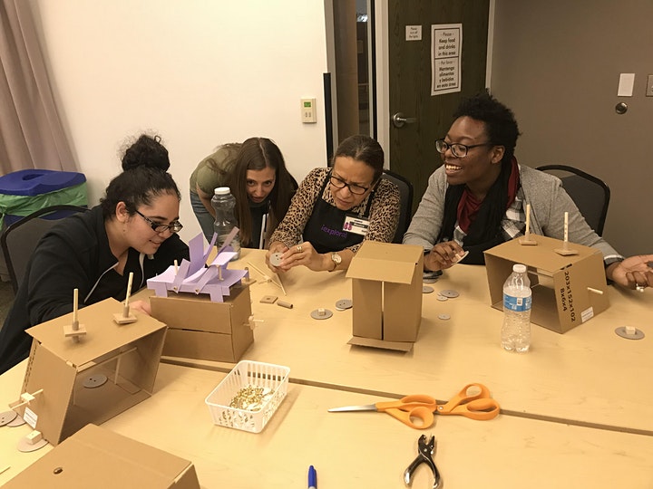 A group of women working on cardboard automata