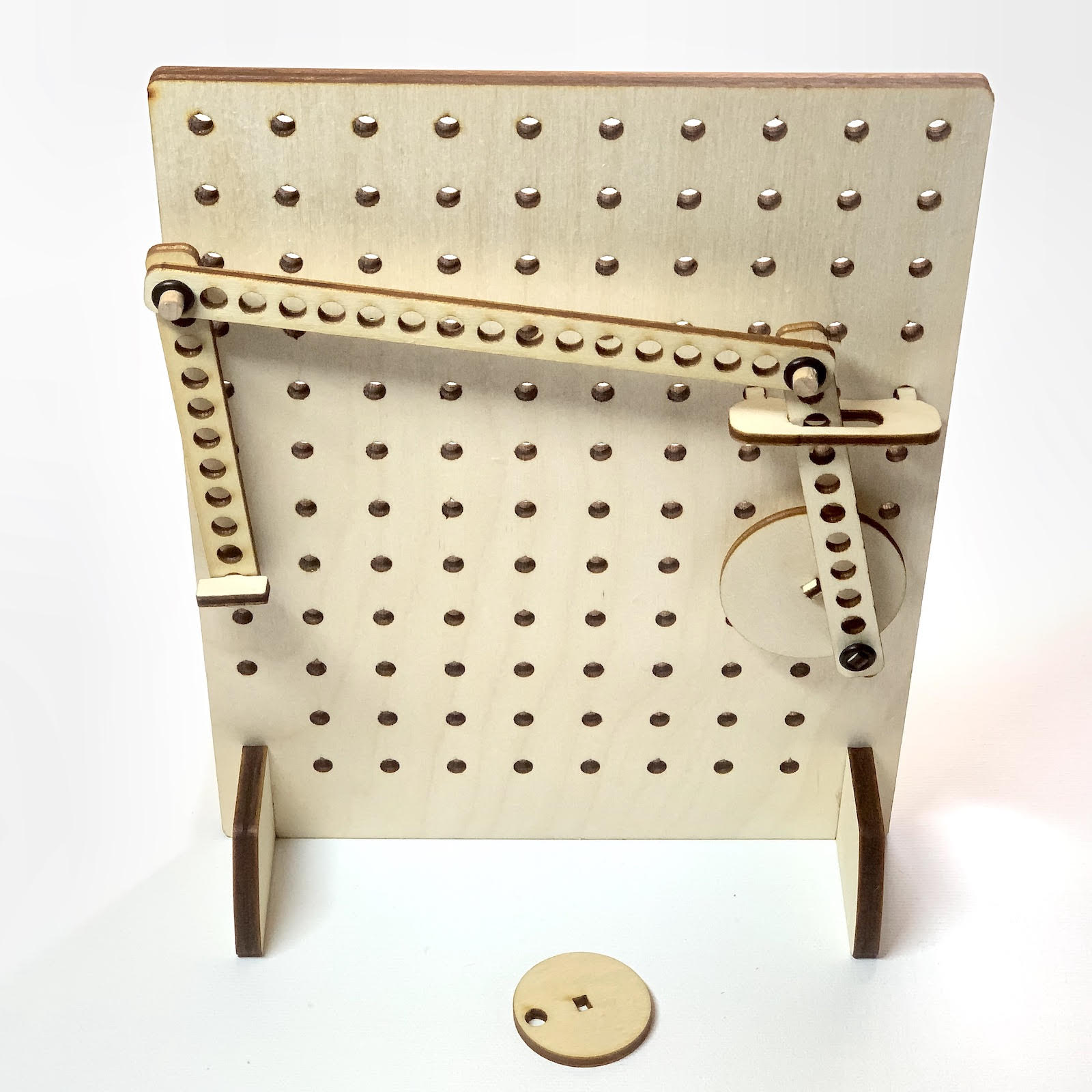 wooden pegboard with mechanical linkages