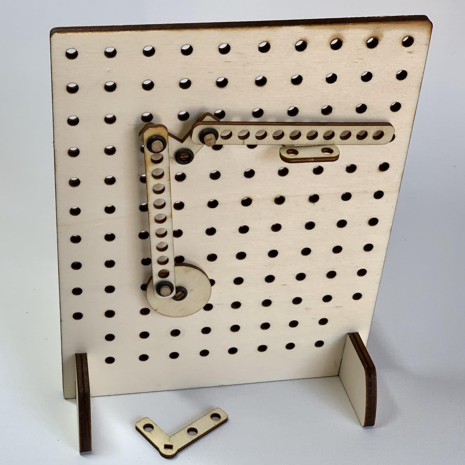 wooden pegboard with cam and linkages