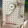 A ratchet built on a wooden pegboard from laser cut parts.