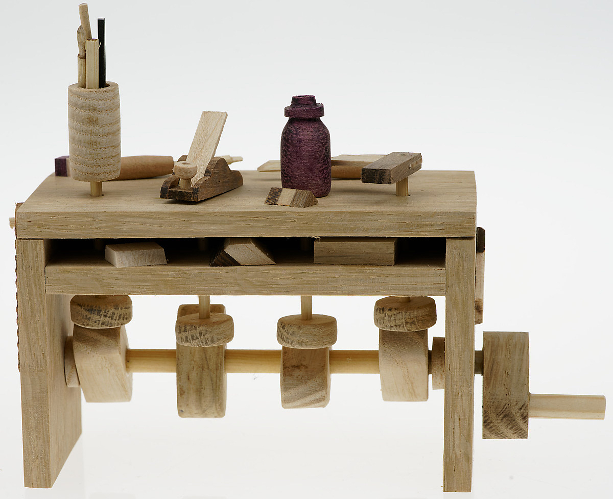 Wooden workbench with carved tools on top