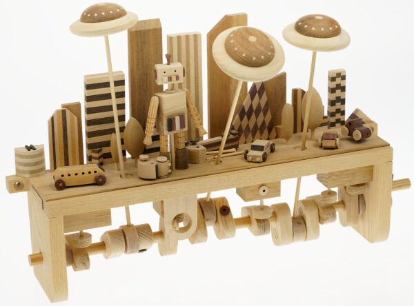 Handmade Wooden Automaton. A large robot stands in a city scene whilst flying saucers move back and forth overhead.