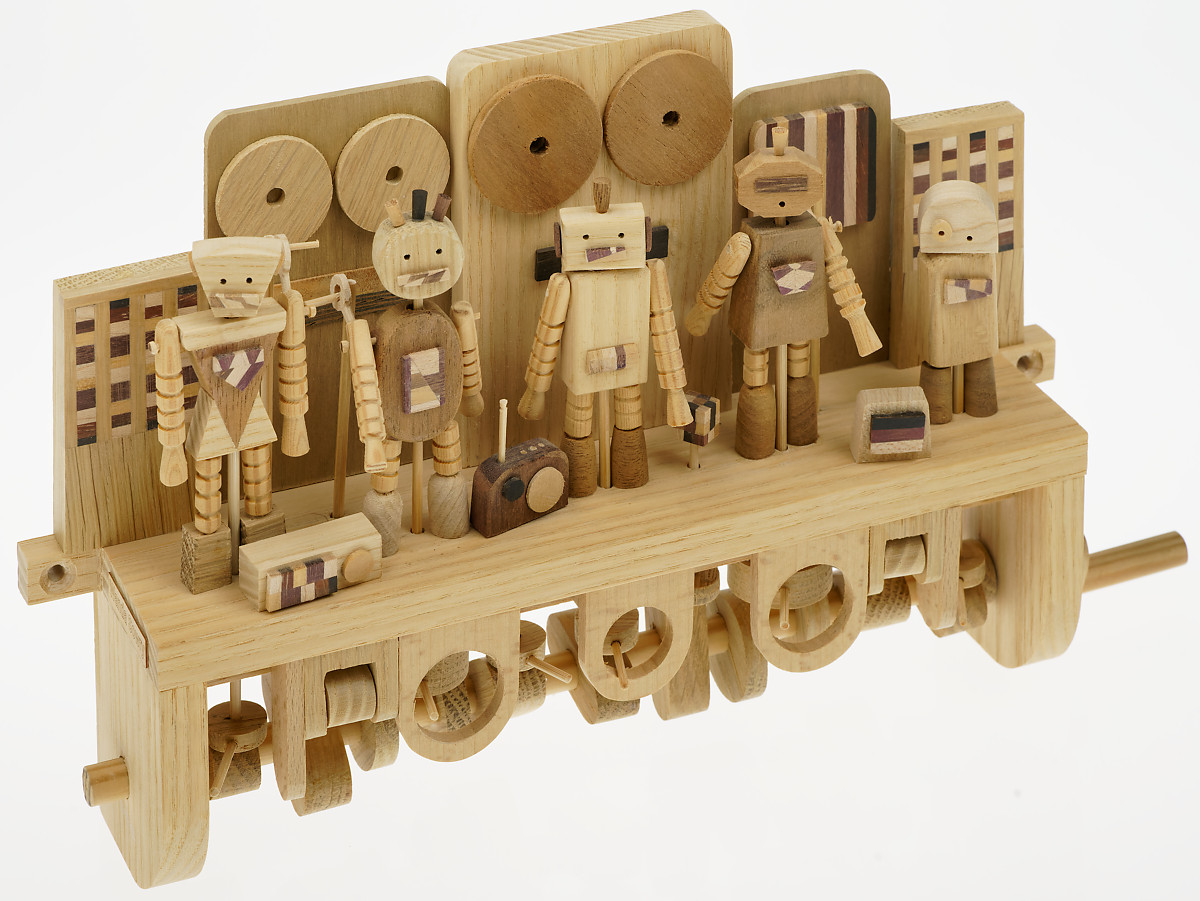 Handmade wooden automaton. 5 dancing wooden robots against a backdrop of speakers