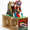 Brightly painted wooden automata. the ring master faces away from the lion.