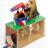 Brightly painted wooden automata. the ring master ducks his head into the open mouth of the lion..