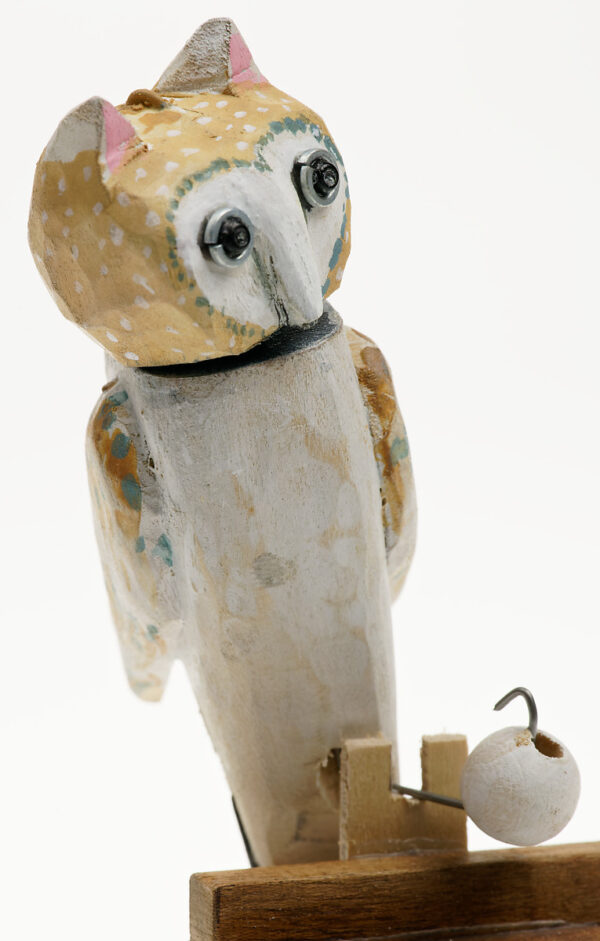 A carved wooden owl automata