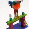 A brightly painted wooden automaton. The Rooster stands to devour a slice of watermelon