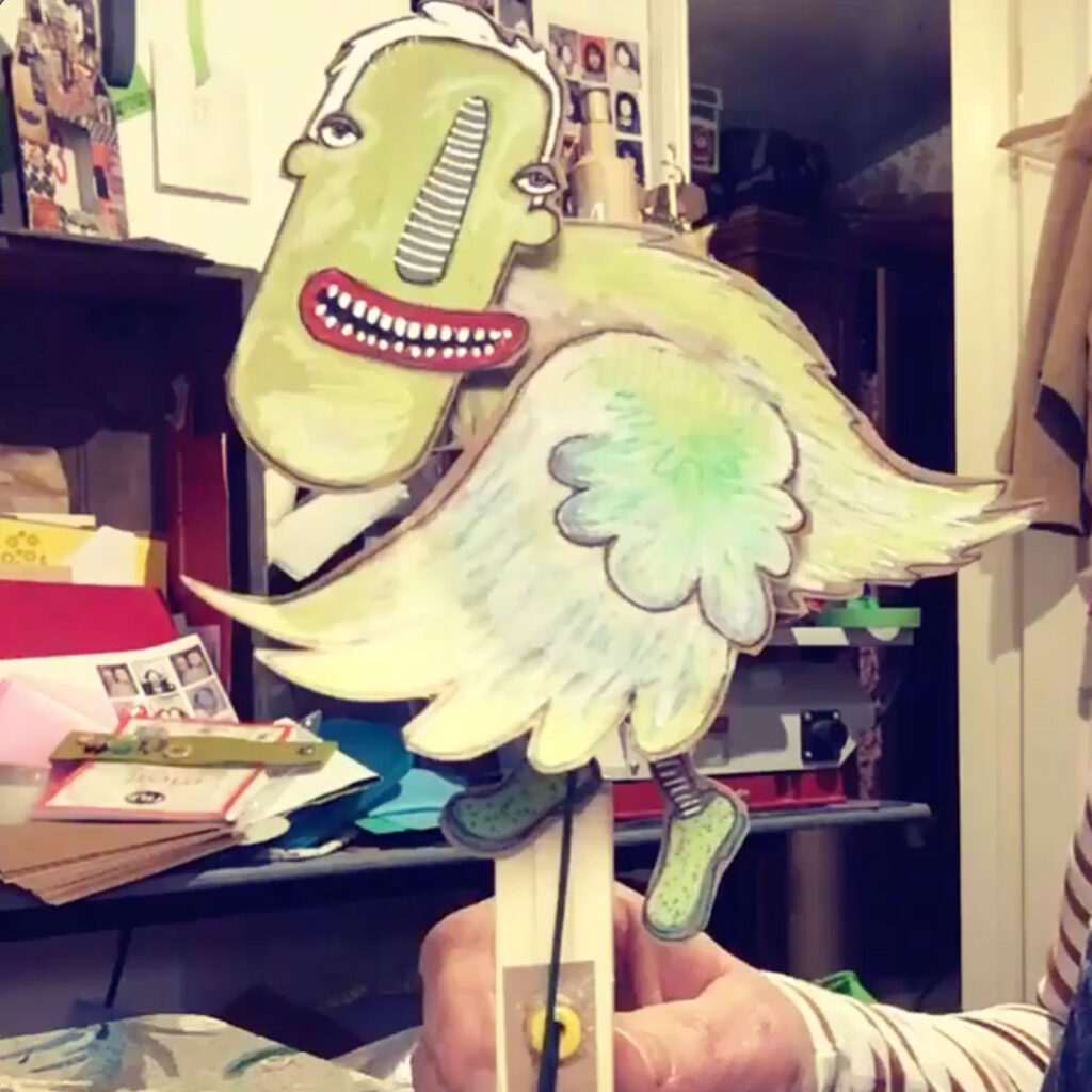 A green bird with a strangely human face
