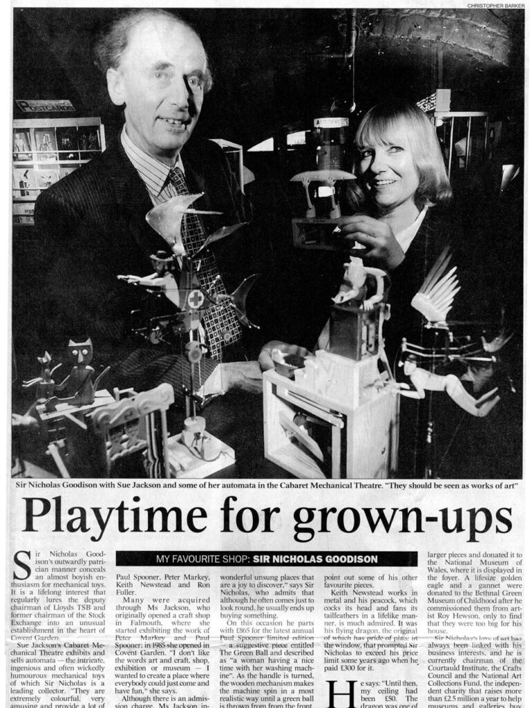 Newspaper article: headline Playtime for grown-ups. Pictured Sir Nicholas Goodison and Sue Jackson with a number of automata.