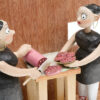 Scary dolls slicing meat