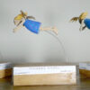 3 Carved wooden angels, floating on spring wire