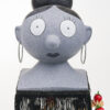 Grey dolls head with hoop earrings and black hair in a bun