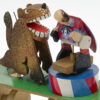 Brightly painted wooden automata. The ring master leans towards the lion.