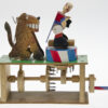 Brightly painted wooden automata. The ring master faces away from the lion.
