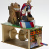 Brightly painted wooden automata. The ring master faces away from the lion.